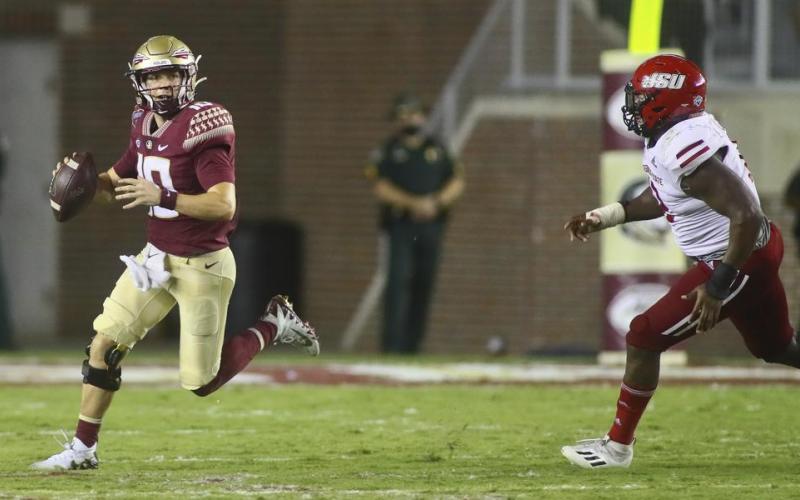 Florida State quarterback McKenzie Milton (10) scrambles out of the pocket as he is chased by Jacksonville State defensive end Umstead Sanders (12) on Sept. 11 in Tallahassee. Jacksonville State won 20-17. (PHIL SEARS/Associated Press)