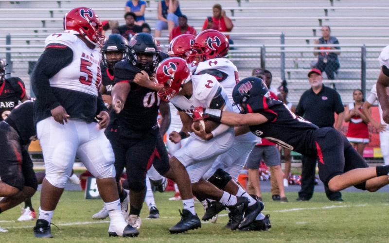 Fort White’s defense converges for a tackle against Hamilton County on Sept. 10. (CHRISTINA FEAGIN/Special to the Reporter)