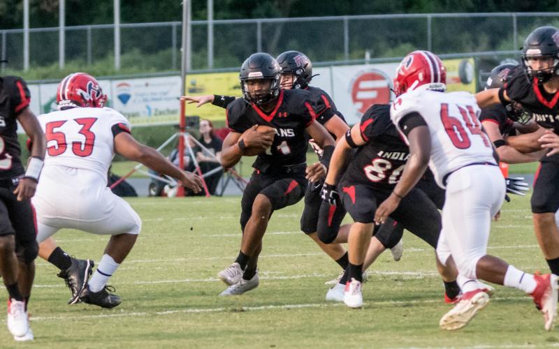 Fort White running back Davone Calhoun takes a carry up the middle against Hamilton County on Friday night. (CHRISTINA FEAGIN/Special to the Reporter)