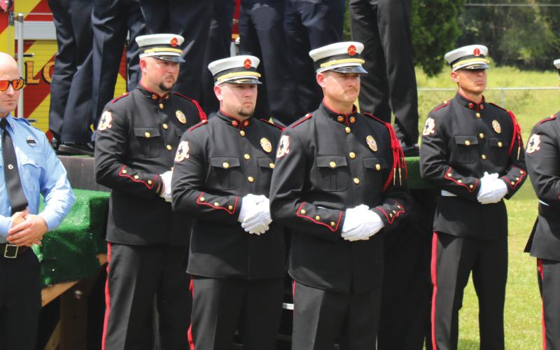 The Suwannee County Fire Rescue Honor Guard stands at attention at the funeral of former Chief Randy Burnham. (TONY BRITT/Lake City Reporter)