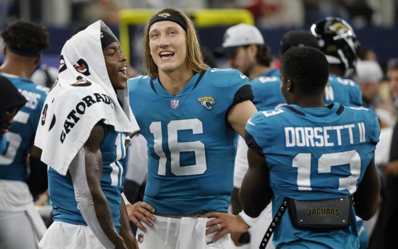 Jacksonville Jaguars' Laviska Shenault Jr., left, Trevor Lawrence (16) and Phillip Dorsett II (13) talk on the sideline during a preseason game against the Dallas Cowboys on Aug. 29, in Arlington, Texas. (MICHAEL AINSWORTH/Associated Press)