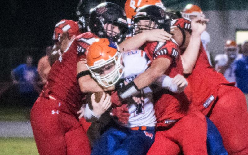 Branford receiver Brice Criggall gets tackled by a swarm of Fort White defenders on Friday night. (CHRISTINA FEAGIN/Special to the Reporter)