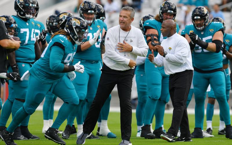 Jacksonville Jaguars head coach Urban Meyer and assistant head coach Charlie Strong get their players motivated before the start of Sunday's game against the Tennessee Titans in Jacksonville. (BOB SELF/Florida Times-Union/TNS)