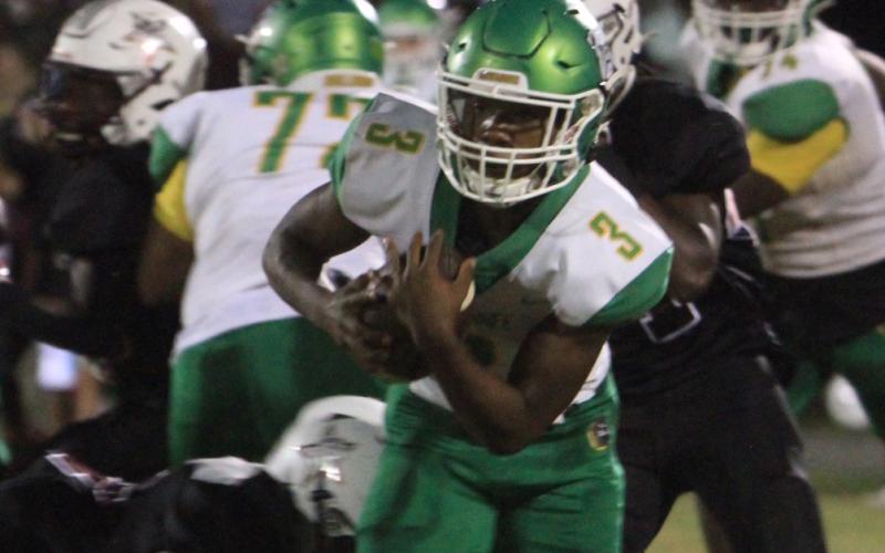 Suwannee running back Malachi Graham runs past a Madison County tackler on Oct. 8. (PAUL BUCHANAN/Special to the Reporter)