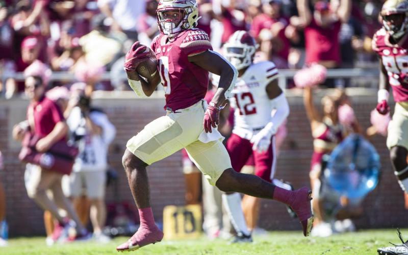 Florida State running back Jashaun Corbin (0) breaks through the line for a touchdown run against Massachusetts on Oct. 23 in Tallahassee. (MARK WALLHEISER/Associated Press)