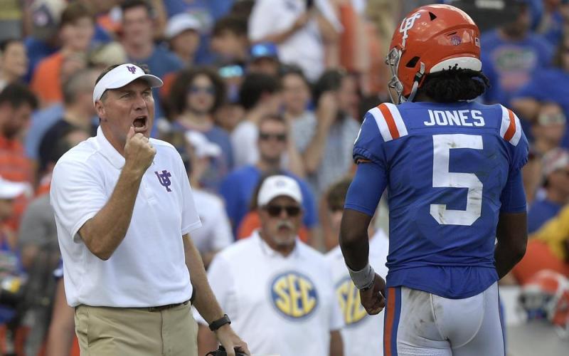 Florida head coach Dan Mullen, left, calls out instructions in front of quarterback Emory Jones (5) during a game against Vanderbilt on Oct. 9 in Gainesville. (AP Photo/PHELAN M. EBENHACK/Associated Press)