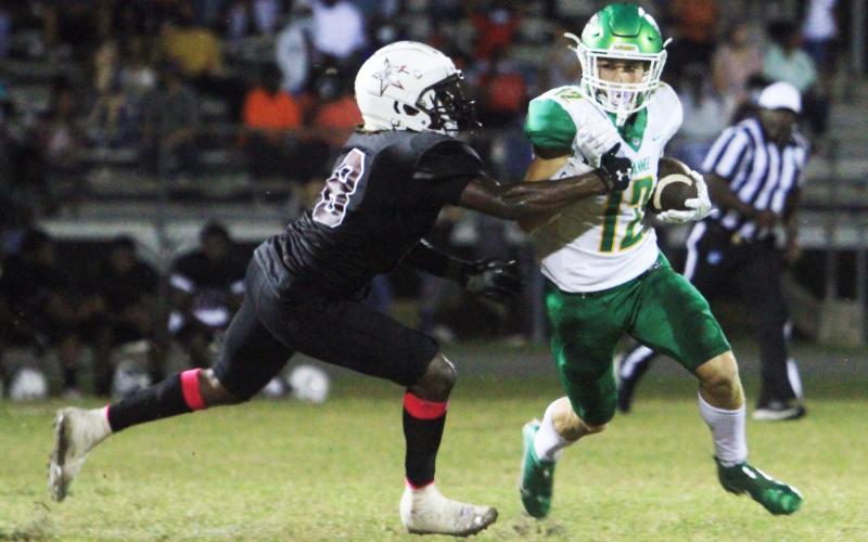 Suwannee receiver Camdon Frier runs up the field after a catch against Madison County on Friday. (PAUL BUCHANAN/Special to the Reporter)