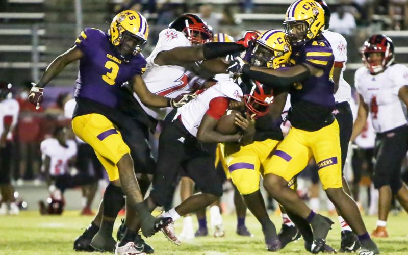 Columbia defensive back Jerome Fulton (3), defensive tackle Jihycein Weston (57) and defensive end Rashod Bradley (43) converge for a tackle vs. Westside on Oct. 1. (BRENT KUYKENDALL/Lake City Reporter)