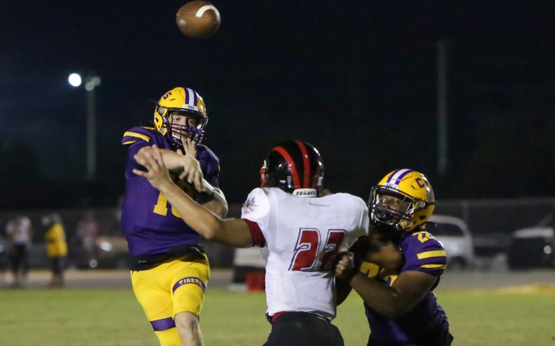 Columbia quarterback Kade Jackson throws a pass over a Westside defender last Friday. (BRENT KUYKENDALL/Lake City Reporter)