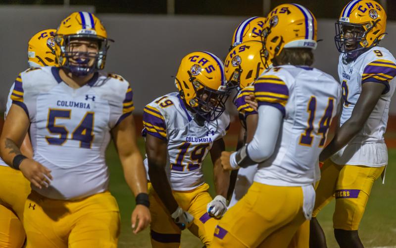 Columbia running back Leo Robinson (19) celebrates with teammates after scoring a touchdown against Orange Park on Friday. (FRAN RUCHALSKI/Special to the Reporter)