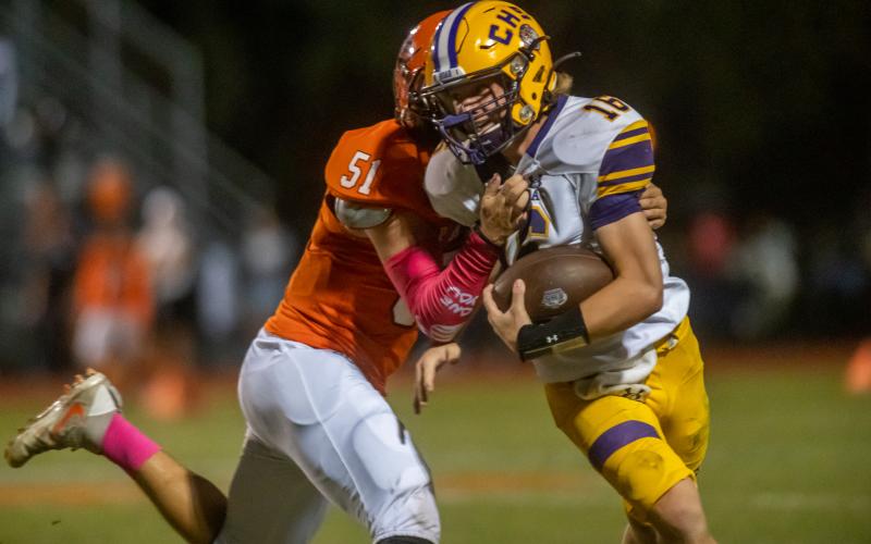 Columbia quarterback Evan Umstead tries to escape a tackle from Orange Park defensive lineman Britton Roberts on Oct. 15. (FRAN RUCHALSKI/Special to the Reporter)