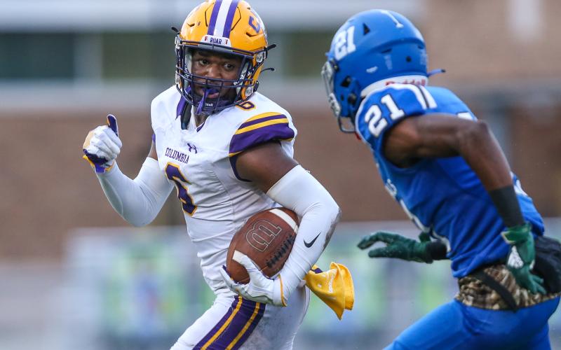 Columbia receiver Tray Tolliver runs up the field pursued by Riverside cornerback Joe Morrison during last Friday's game. (GARY LLOYD MCCULLOUGH/Special to the Reporter)