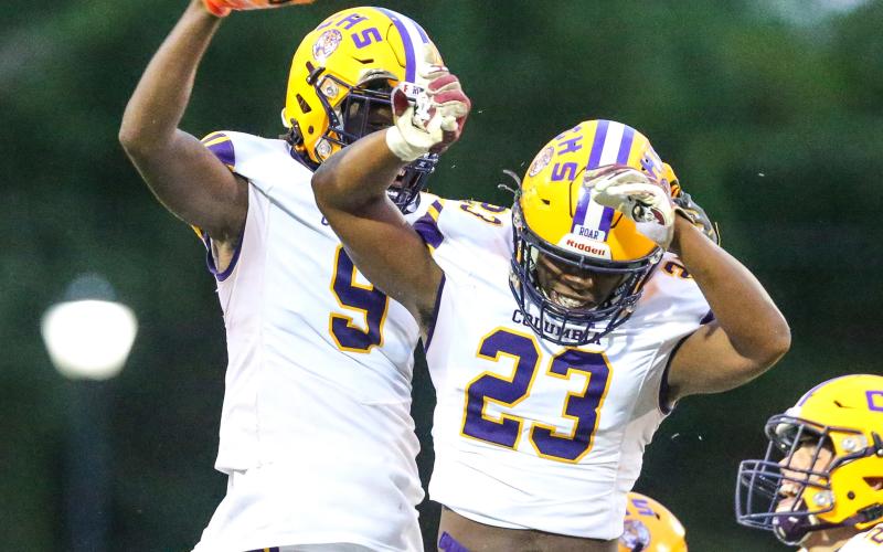 Columbia linebacker Tyrell Peterson celebrates with receiver Brae Deal after a fumble recovery against Riverside on Friday. (GARY LLOYD MCCULLOUGH/Special to the Reporter)