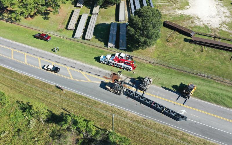 A full load of overturned building trusses shut down a portion of Bascom Norris Drive on Friday afternoon after the load shifted on the trailer coming out of a turn. (RAY CARPENTER/Special to the Reporter)