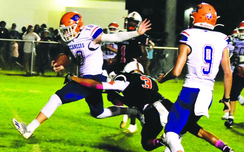 Branford quarterback Kyson Johnson gets hit by a Trenton defender just as he crosses the goal line for a touchdown on Friday. (ROB WOLFE/Special to the City Reporter)
