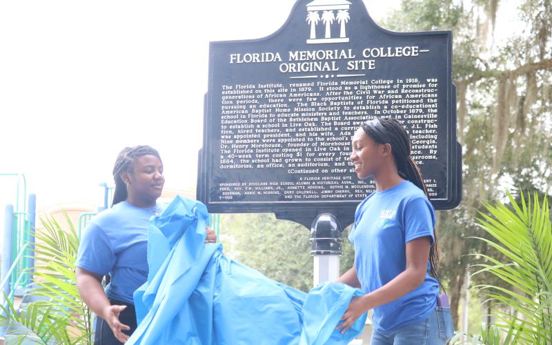 Members of the D.E.V.O.T.E.D 4-H Club unveil the historical marker at the original site of Florida Memorial University in Live Oak on Saturday. (JAMIE WACHTER/Lake City Reporter)