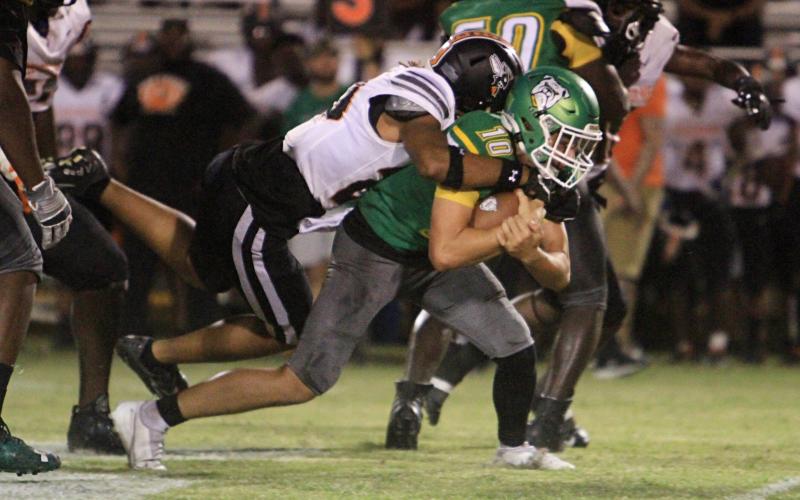 Suwannee quarterback Kodi Lang is tackled by a Hawthorne defender on Friday night. (PAUL BUCHANAN/Special to the Reporter)