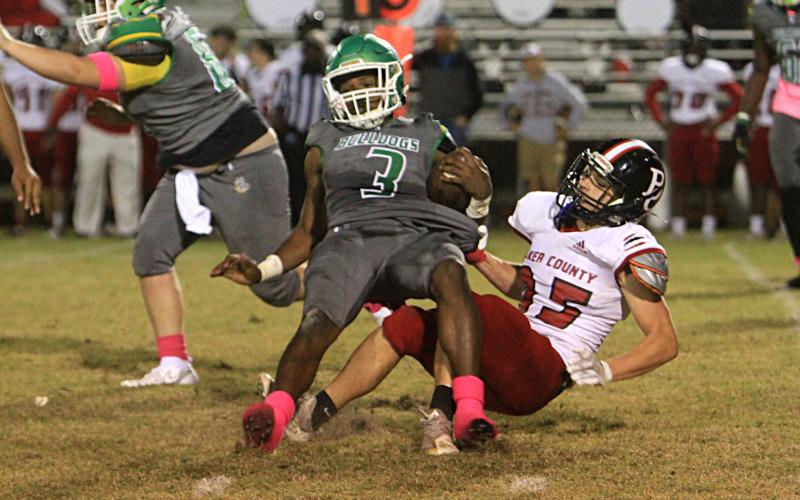 Suwannee running back Malachi Graham is tackled from behind by a Baker County defender on Friday. (PAUL BUCHANAN/Special to the Reporter)