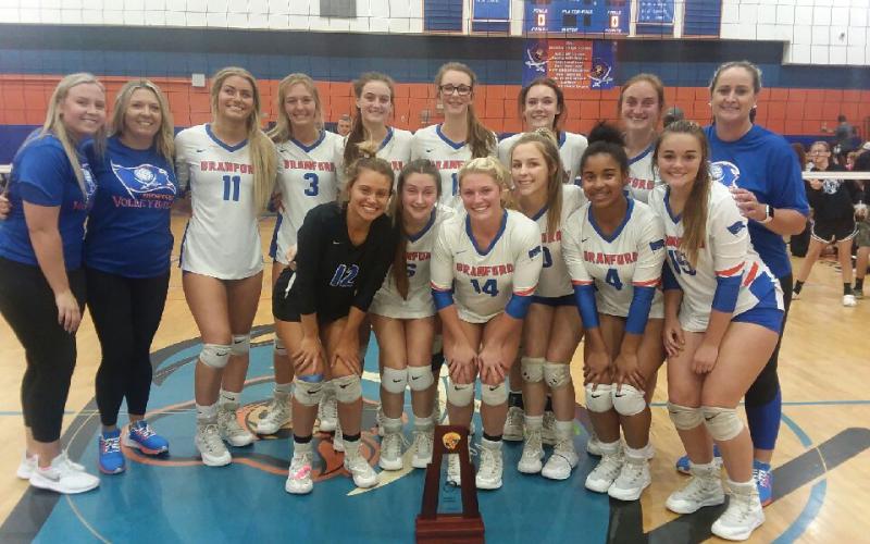 Branford’s volleyball team poses with the District 5-1A championship trophy after defeating Lafayette in five sets Thursday night. (CONCEPCION LEDEZMA/Special to the Reporter)