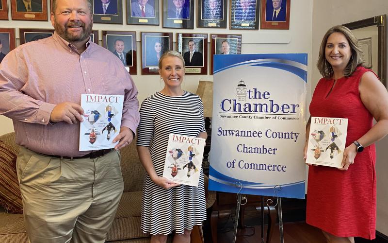 Hillary Cannon, center, executive director of the Suwannee County Chamber of Commerce stands with Lake City Reporter Publisher Todd Wilson, left, and Monja Slater, Lake City Reporter business development manager, during the unveiling of the Chamber’s 2021-2022 ‘Impact’ magazine this week. The Reporter partnered with the Suwannee Chamber to produce the annual magazine. (COURTESY)