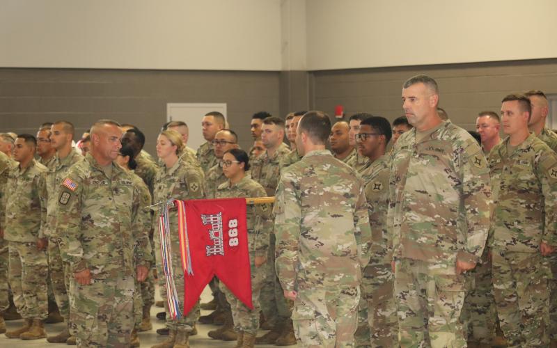 Members of the 868 Engineering Construction Company prepare to ‘case the colors’ on Saturday. (JAMIE WACHTER/Lake City Reporter)