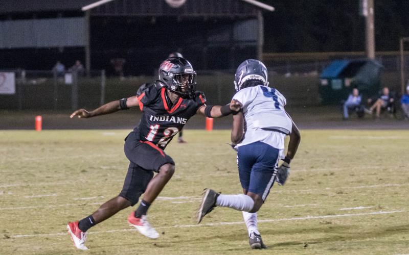 Fort White defensive back Najeeb Smith, bumping a PK Yonge receiver at the line of scrimmage, had two interceptions, including a pick-6. (CHRISTINA FEAGIN/Special to the Reporter)