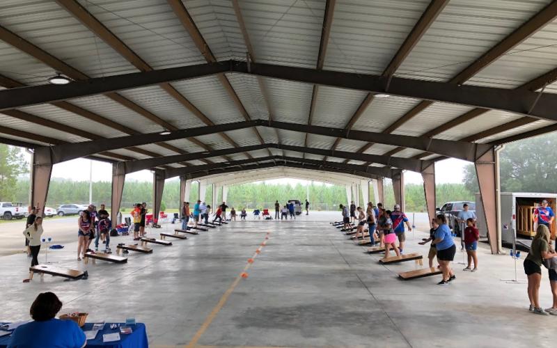 Participants in the fourth annual Suwannee Valley Cornhole Tournament play their matches on Saturday during the event. (COURTESY)