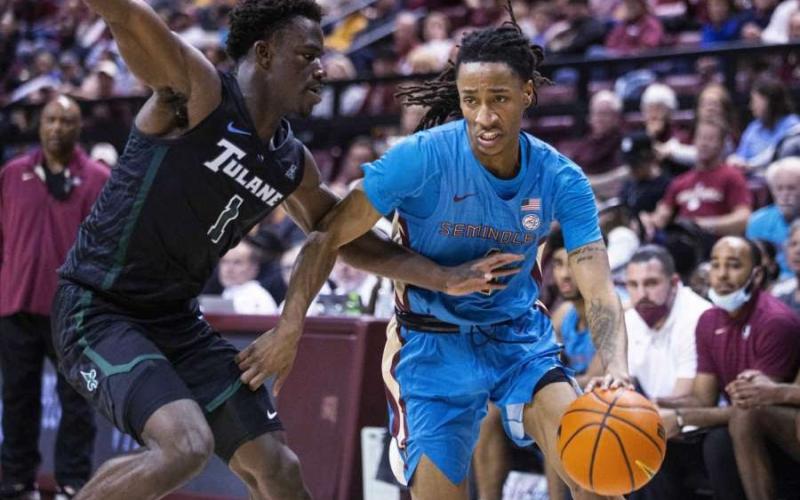 Florida State guard Caleb Mills (4) tries to get past Tulane guard Sion James (1) during Wednesday’s game in Tallahassee, Fla., Wednesday, Nov. 17, 2021. (MARK WALLHEISER/Associated Press)