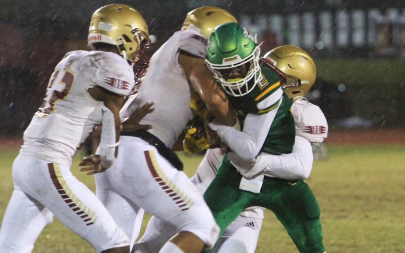 Suwannee receiver Jay Smith is tackled by a host of Florida High defenders on Friday night. (PAUL BUCHANAN/Special to the Reporter)