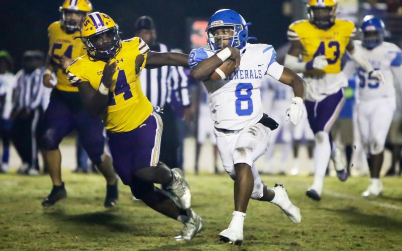 Columbia defensive end Bobby Miller chases after Riverside quarterback Cale Zarah during Friday’s Region 1-6A quarterfinal. (BRENT KUYKENDALL/Lake City Reporter)