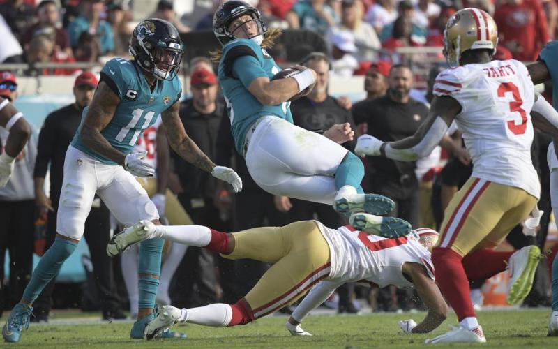 Jacksonville Jaguars quarterback Trevor Lawrence is upended by San Francisco 49ers cornerback Ambry Thomas during Sunday’s game in Jacksonville, Fla. (PHELAN M. EBENHACK/Associated Press)