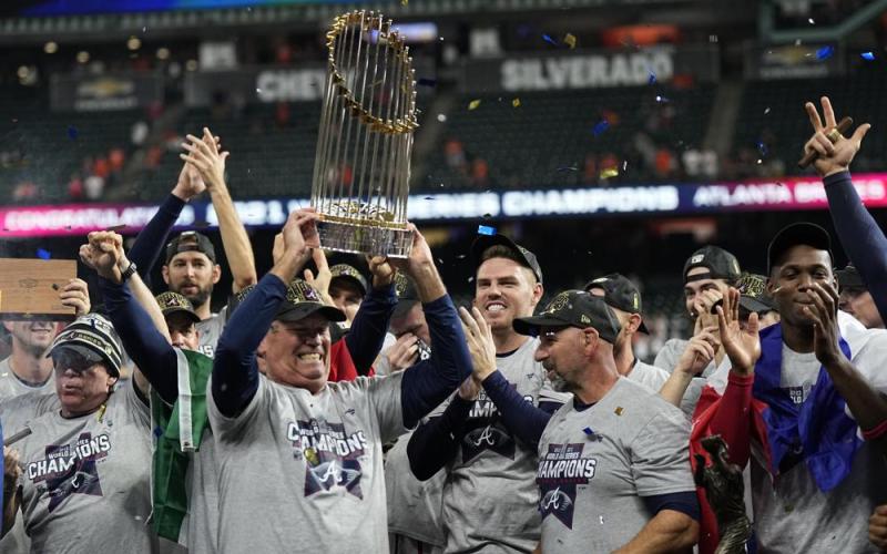 Atlanta Braves manager Brian Snitker holds up the trophy after winning the World Series in Game 6 against the Houston Astros on Tuesday in Houston. The Braves won 7-0. (DAVID J. PHILLIP/Associated Press)