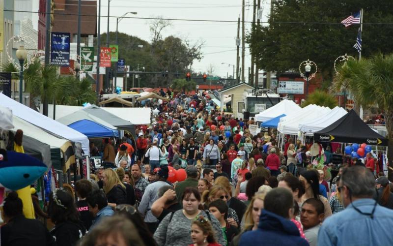 A crowd attends a previous year’s Christmas on the Square festival in Live Oak. The festival returns for the 37th year, starting Thursday and running through Dec. 4. (FILE)