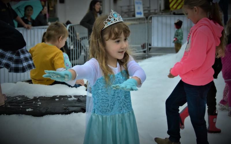 A child lets some snow go during ‘Snow on the Square,’ part of the Christmas on the Square festival in Live Oak. (ROB WOLFE FILE/Special to the Reporter)