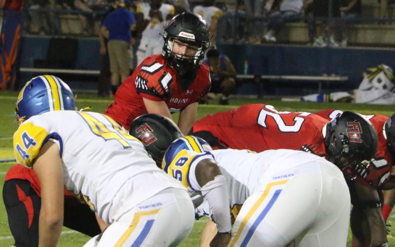 Fort White quarterback Clayton Philpot gets set to take a snap against Newberry on Sept. 3. (FILE)