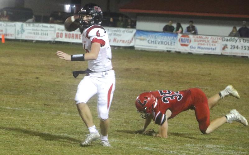 Fort White quarterback Clayton Philpot rolls out to pass against Lafayette during Friday’s Region 3-1A quarterfinal. (MORGAN MCMULLEN/Lake City Reporter)