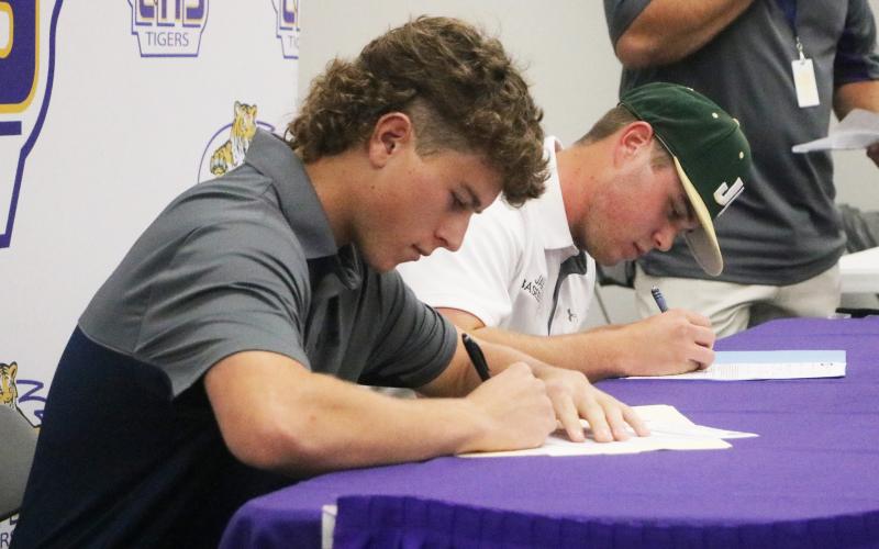 Columbia baseball players Truitt Todd (left) and Brent Howard (right) sign their letters of intent on Wednesday. Todd signed with Florida State College at Jacksonville and Howard signed with Jacksonville. (JORDAN KROEGER/Lake City Reporter)