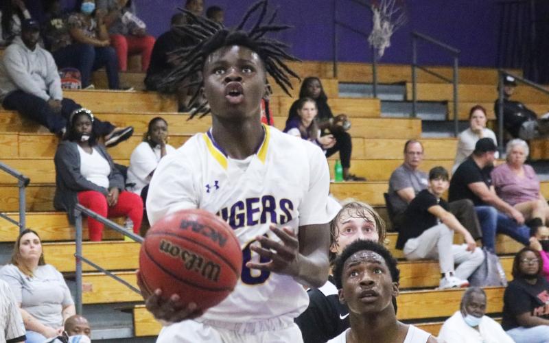 Columbia guard Isaac Broxey rises to shoot against Hawthorne last season. (FILE)