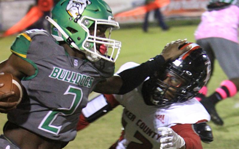 Suwannee receiver Jay Smith stiff arms a Baker County defender on Oct. 29. (PAUL BUCHANAN/Special to the Reporter)