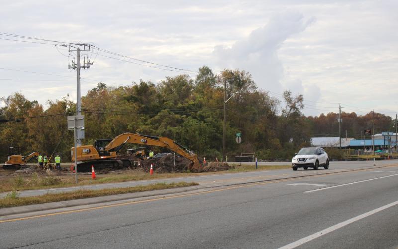 A construction crew works on digging ground for a new roundabout near Bascom Norris Drive. (TONY BRITT/Lake City Reporter)