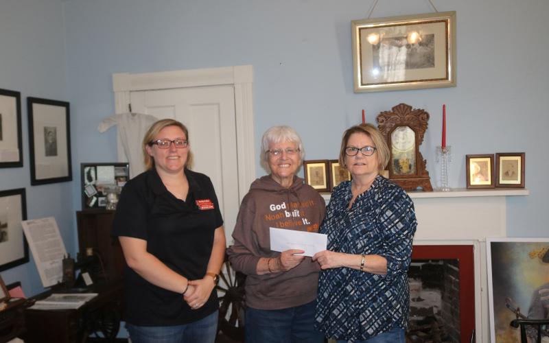 Rose Pavey (middle), the trustee from the Aloysius (Al) Harter trust, donates $25,000 to the Lake City-Columbia County Historical Museum. Accepting the donation for the museum are Kim Estergren (right), the museum president, and Shelly Fuller. (JAMIE WACHTER/Lake City Reporter)
