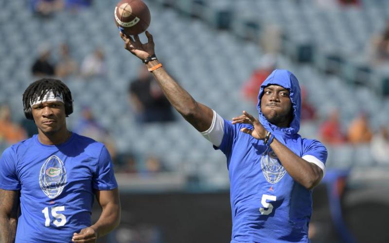 Florida quarterback Emory Jones (5) warms up as quarterback Anthony Richardson (15) watches before a game against Georgia on Oct. 30 in Jacksonville. (PHELAN M. EBENHACK/Associated Press)
