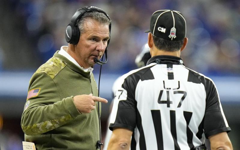Jacksonville Jaguars head coach Urban Meyer talks with line judge Tim Podraza during Sunday's game against the Indianapolis Colts in Indianapolis. (AJ MAST/Associated Press)