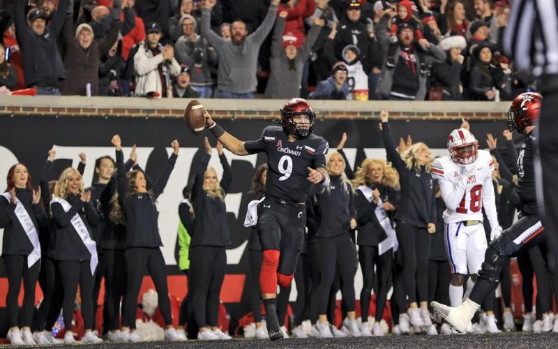 Cincinnati quarterback Desmond Ridder celebrates after catching a touchdown pass against SMU on Saturday in Cincinnati. Cincinnati won 48-14. (AARON DOSTER/Associated Press)