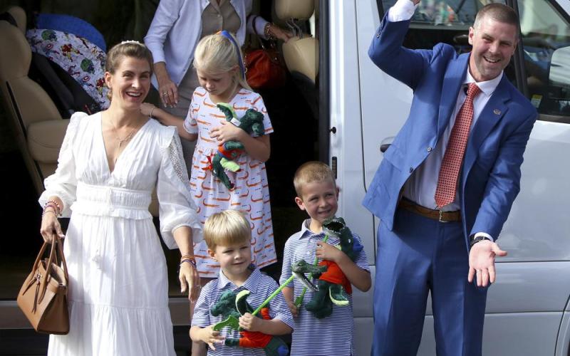 New Florida head coach Billy Napier shakes hands with fans as he and his family arrive at Ben Hill Griffin Stadium on Sunday in Gainesville. (BRAD MCCLENNY/The Gainesville Sun via AP)