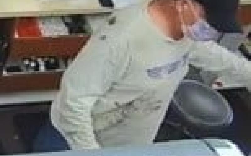 A security footage still from Baya Pharmacy shows the masked suspect. (COURTESY)