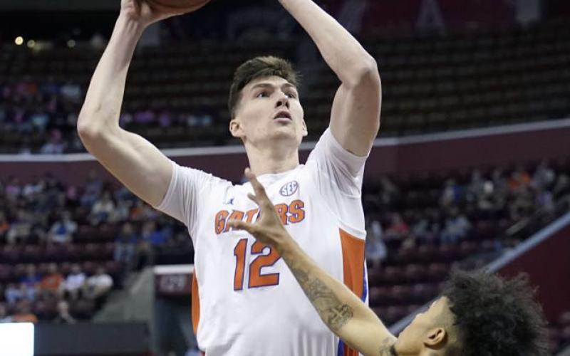 Florida forward Colin Castleton shoots over South Florida guard Caleb Murphy during the Orange Bowl Basketball Classic on Saturday in Sunrise. (LYNNE SLADKY/Associated Press)