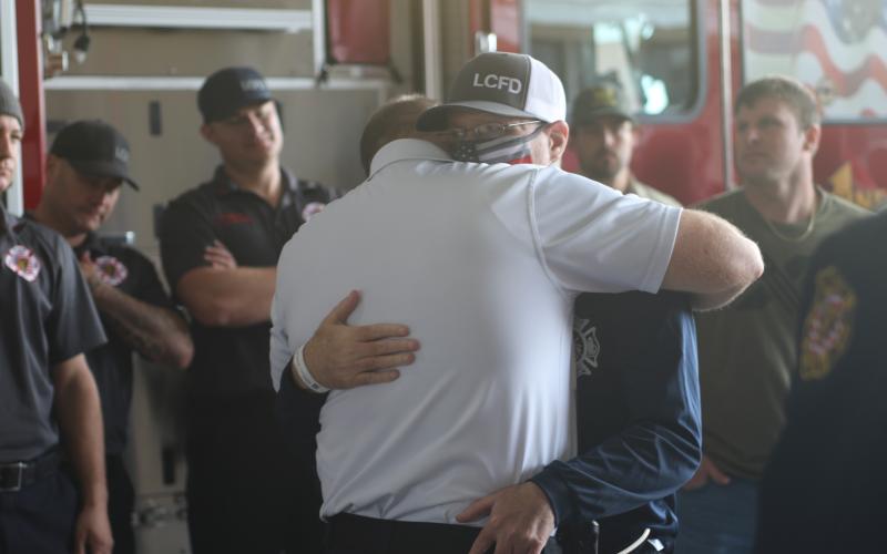 Lake City Fire Department Lt. Jeff McNeill hugs a fellow firefighter Wednesday afternoon at the Lake City Fire Station. McNeill was returning home from rehab in Jacksonville following a lengthy battle and recovery from covid-19. (JAMIE WACHTER/Lake City Reporter)