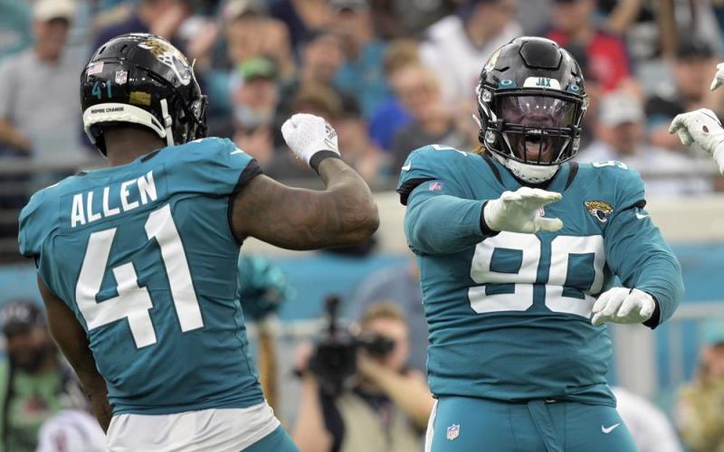 Jacksonville Jaguars defensive tackle Malcom Brown (90) and outside linebacker Josh Allen (41) celebrate a play against the Houston Texans on Dec. 19 in Jacksonville. (PHELAN M. EBENHACK/Associated Press)