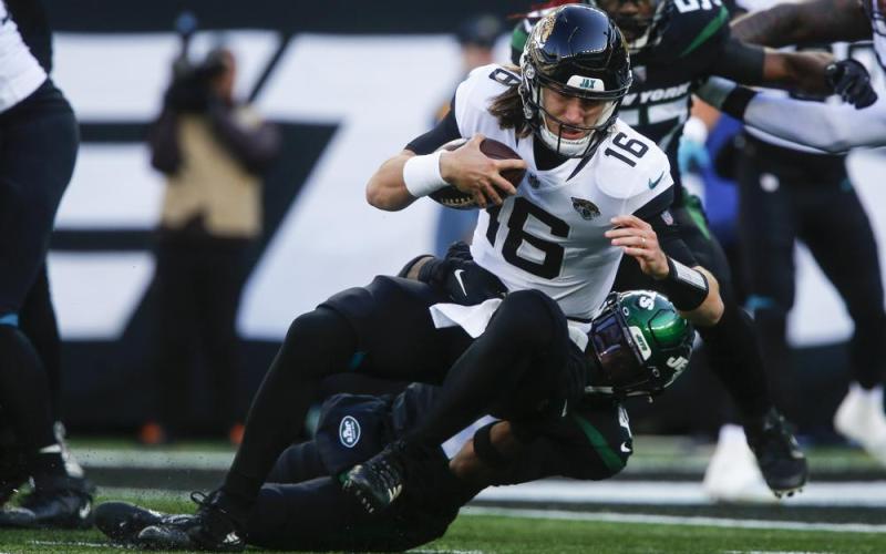 New York Jets cornerback Jason Pinnock tackles Jacksonville Jaguars quarterback Trevor Lawrence during Sunday’s game in East Rutherford, N.J. (JOHN MUNSON/Associated Press)